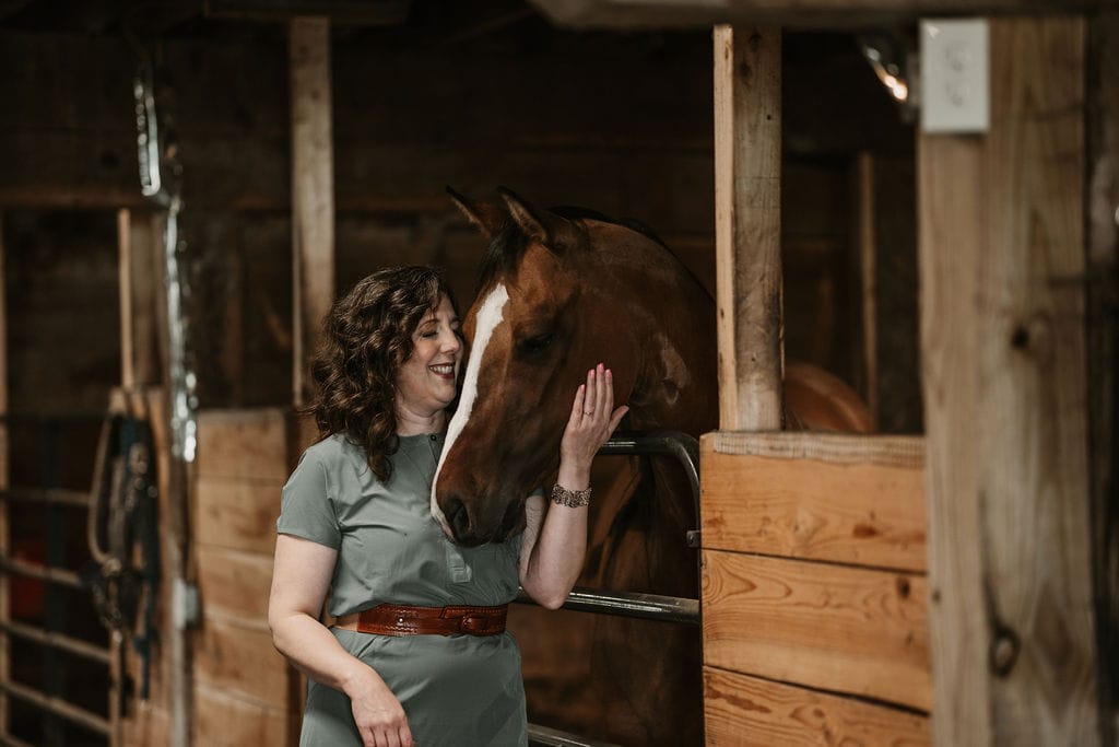 A person gently petting a Labrador Retriever outside in the sunlight - Pet Euthanasia